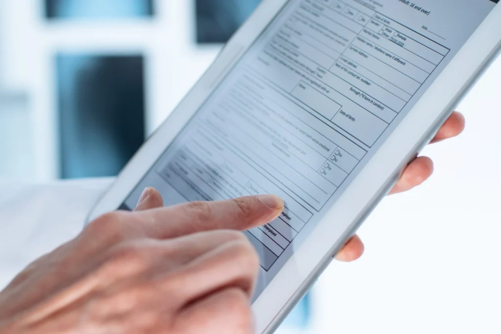 Patient filling out new patient forms on a tablet