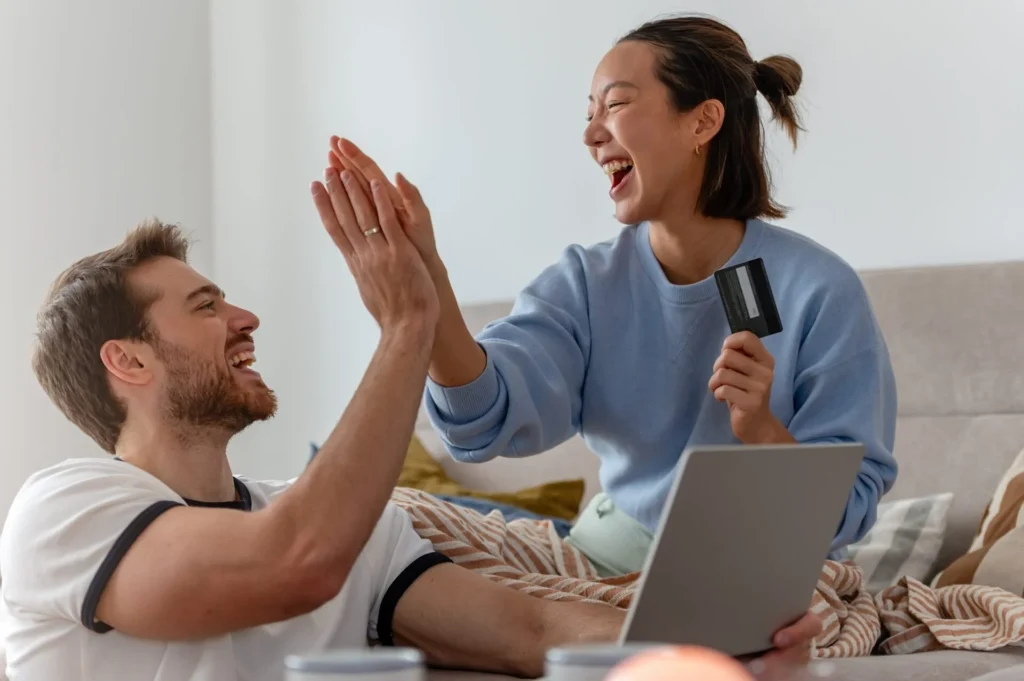 Happy couple celebrating affordable dental financing